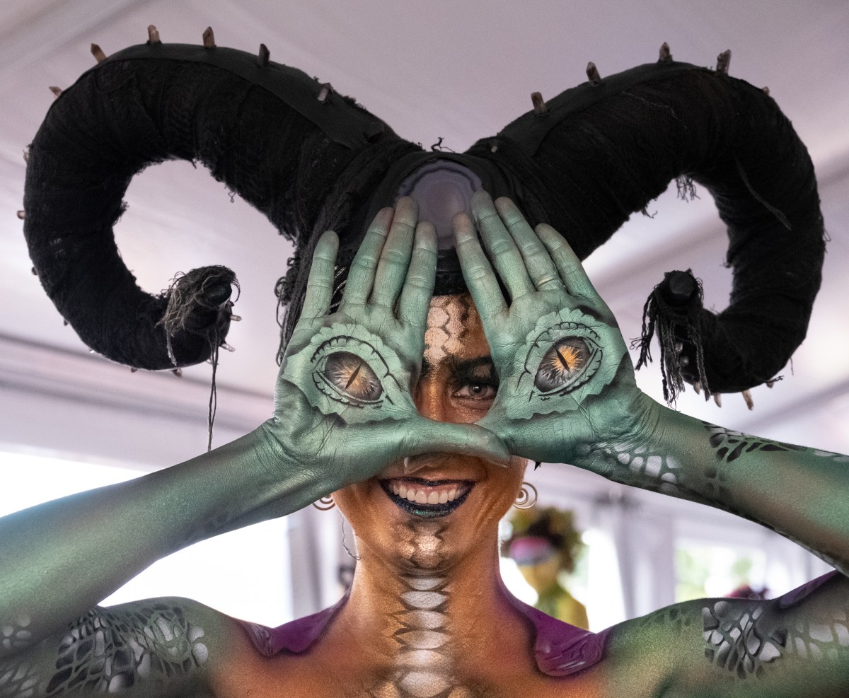 a portrait of a woman with horns and body paint