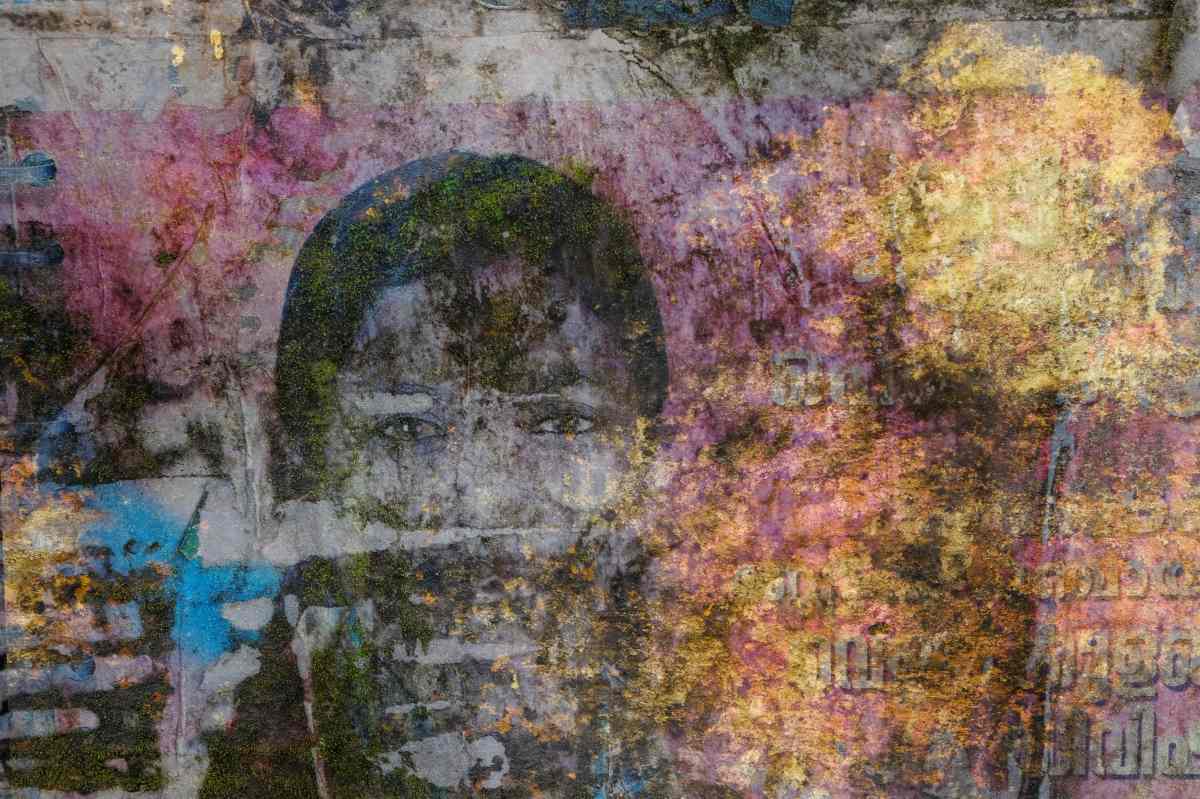 Artistic photo, portrait with double exposure with a colourful faded wall in the background