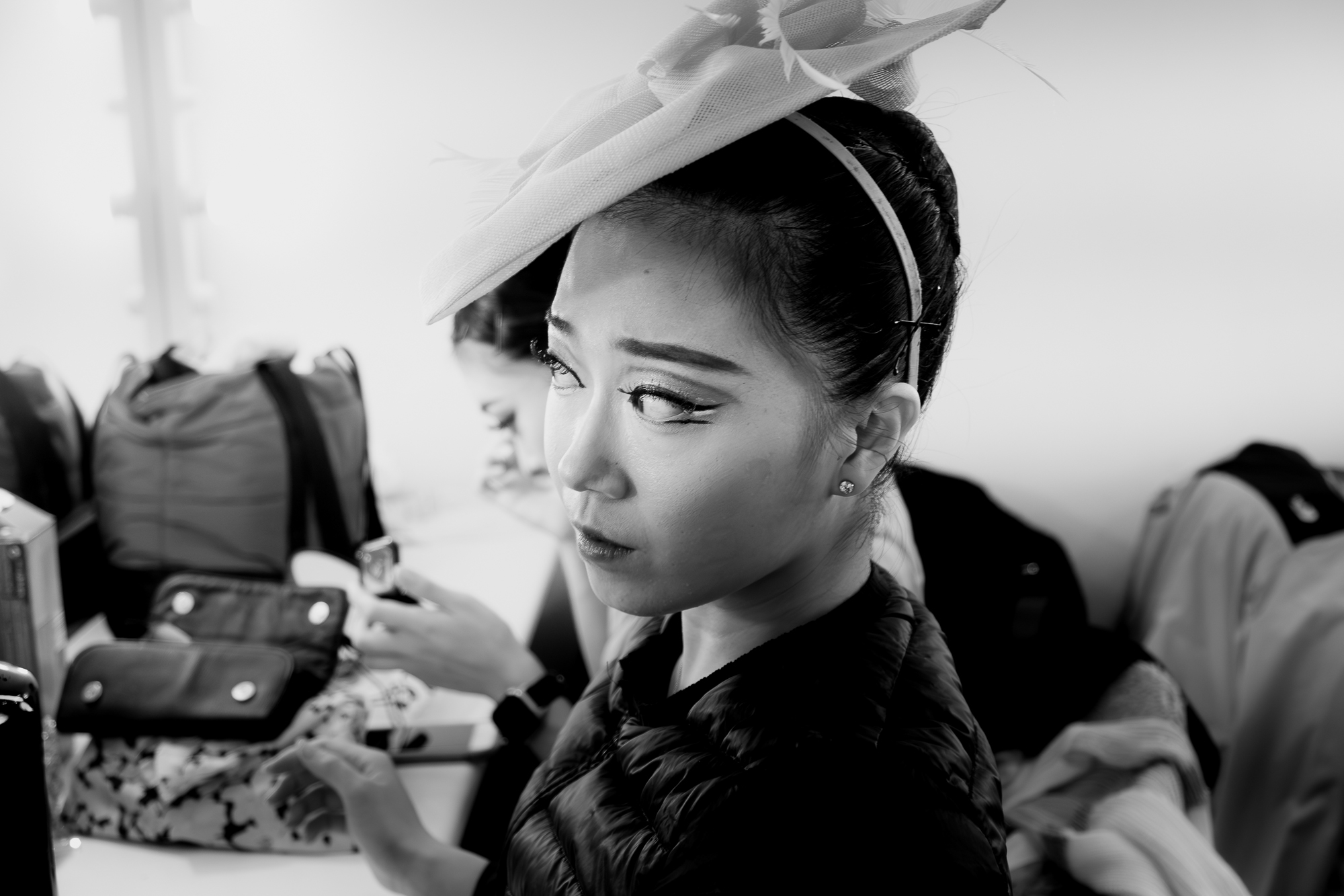 Ballet dancer looking into the mirror getting the makeup ready for a performance