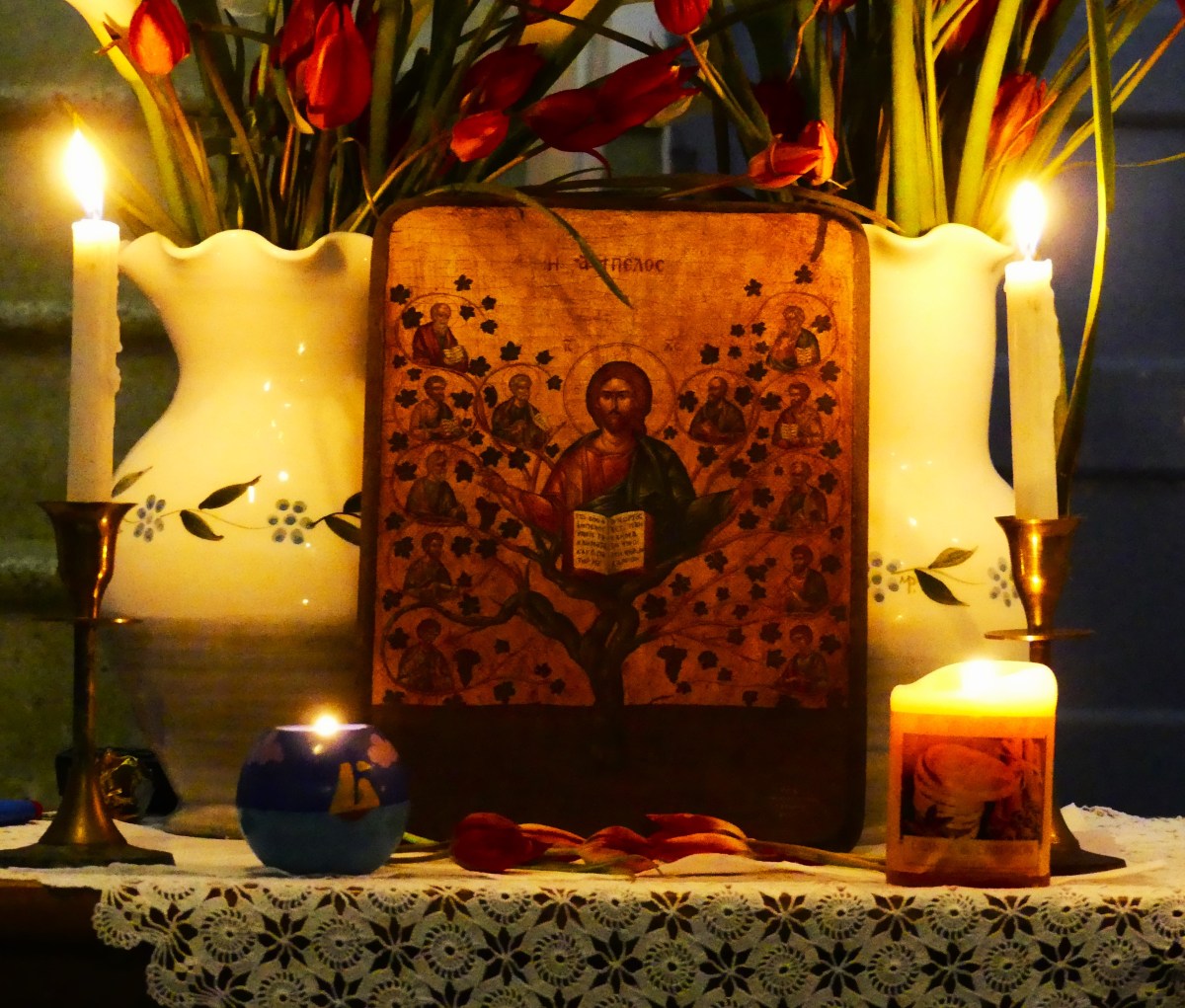 A Greek icon flanked by burning candles